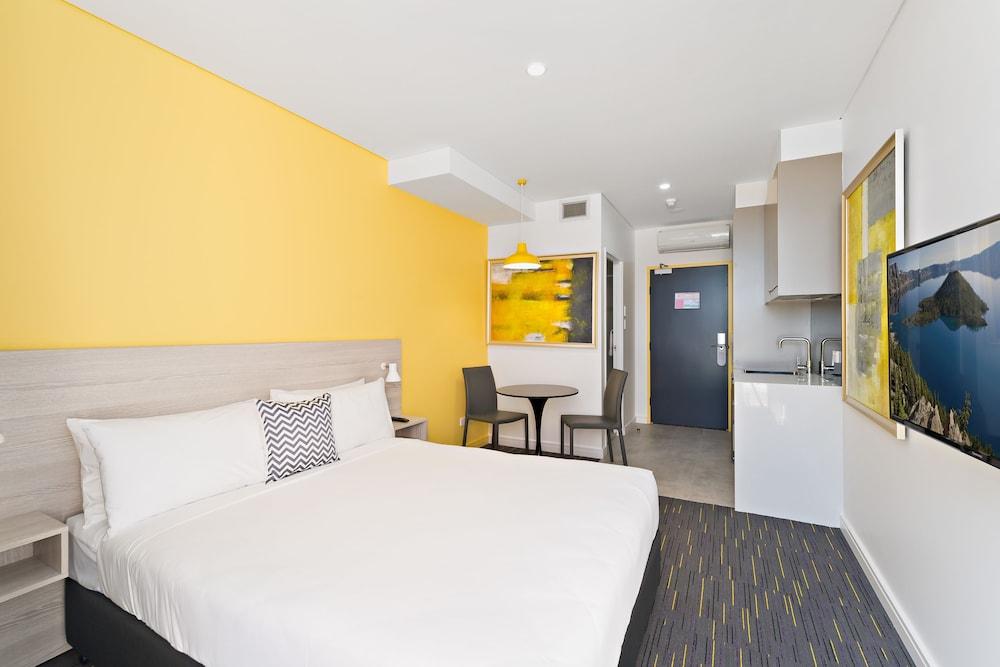 ValueSuites Green Square Room Type - Modern Queen Suite + Grab n Go Bites