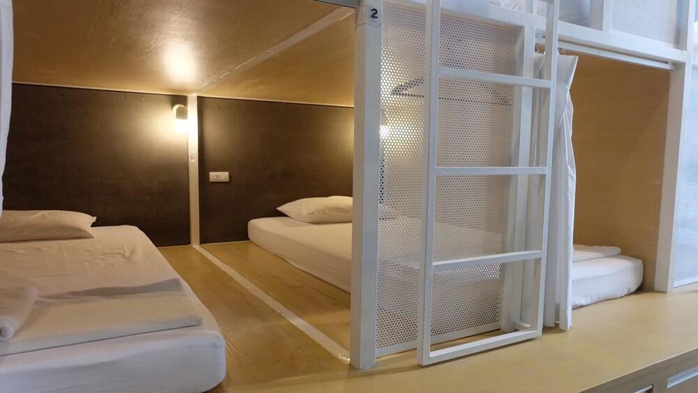 On the bed Hostel Room Type - Deluxe Shared Dormitory, Mixed Dorm