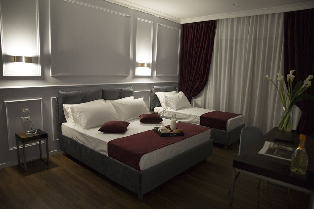 Unicum Roma Suites - Tap to explore photos