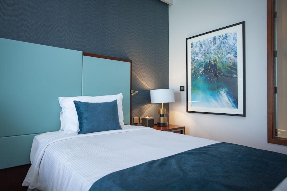 Wyndham Grand Doha West Bay Beach - Tap to explore photos