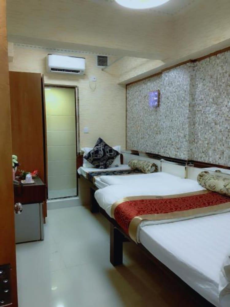 Standard Triple Room - Tap to explore photos