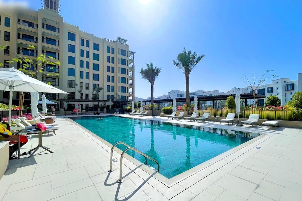 Elegant Pool View 2BR Apartment - Tap to explore photos