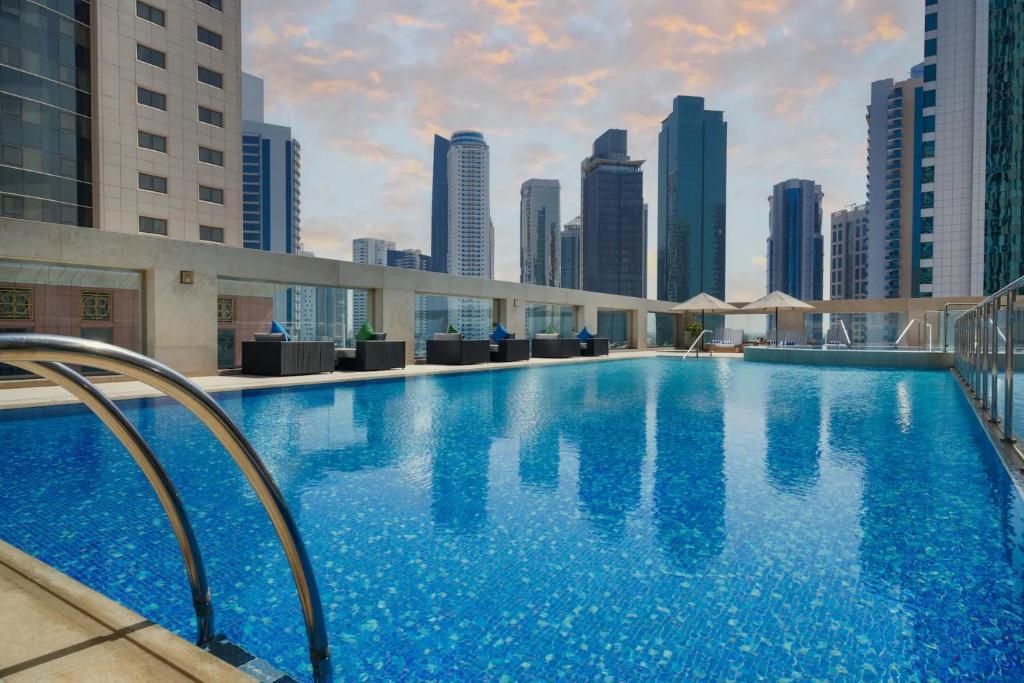 Wyndham Grand Doha West Bay Beach - Tap to explore photos