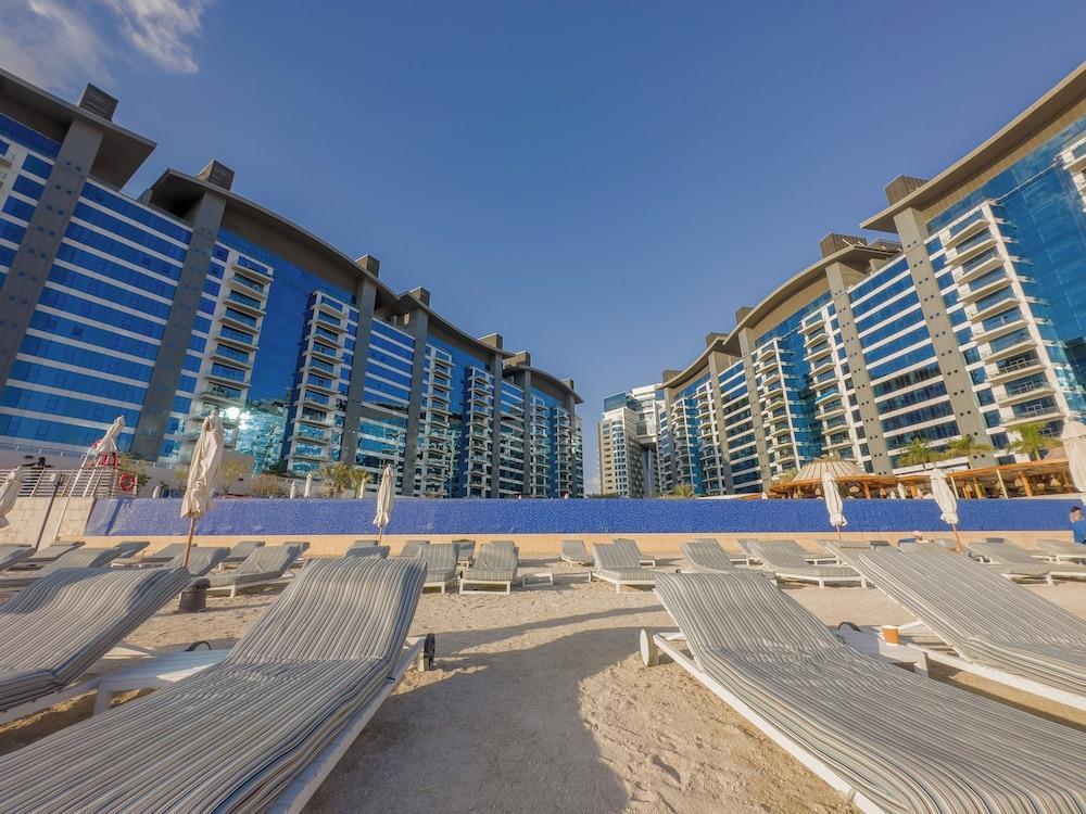 WelHome - Oceanfront Elegance 1BR Apt With Palm Sea Views - Tap to explore photos