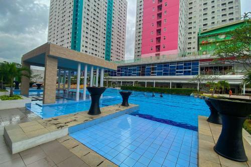 Good Choice and Homey 2BR at Green Pramuka City Apartment By Travelio - Tap to explore photos
