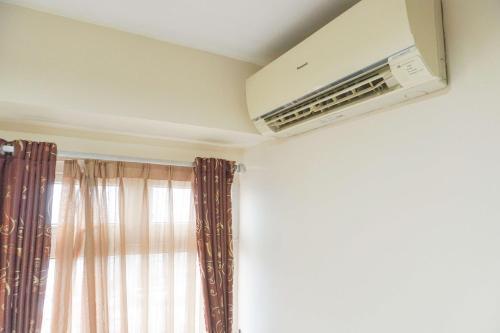 Good Deal and Relaxing 2BR Green Pramuka City Apartment By Travelio - Tap to explore photos