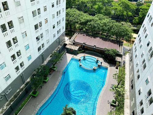 Great Choice and Comfortable 2BR at Green Pramuka City Apartment By Travelio - Tap to explore photos