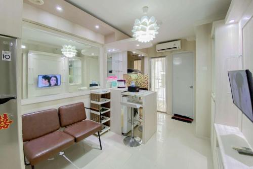 Comfortable and Homey 2BR at Bassura City Apartment By Travelio - Tap to explore photos