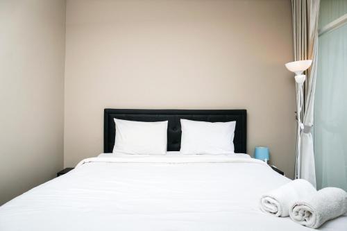 Best Location 2BR Ciputra International Apartment By Travelio - Tap to explore photos