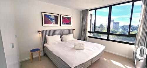 Beautiful harbour views, stylish apartment & pool - Tap to explore photos