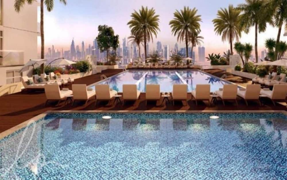 Premium 1BR Oasis - City Views & Pool - Tap to explore photos
