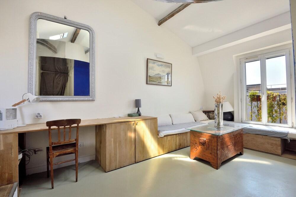 Stylish attic conversion in the rooftops of Paris - Tap to explore photos