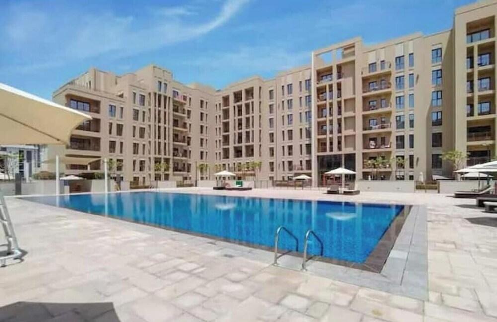 Luxury 2BR w/ Pool, Gym & Balcony – Zahra Breeze - Tap to explore photos