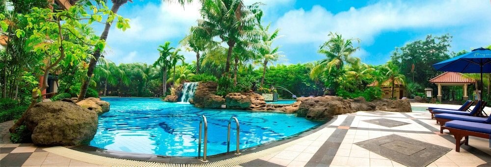 Grand Tropic Suites Hotel - Tap to explore photos